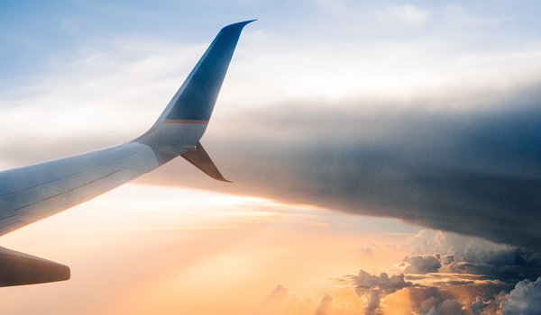 a large passenger jet flying through a cloudy blue sky